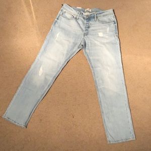 Slim fit, light blue jeans with rips in front side